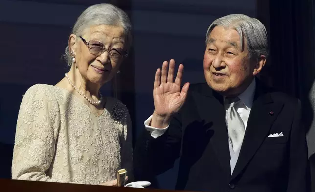 Emperor Emeritus Akihito, right, and Empress Emerita Michiko greet well-wishers from the bullet-proofed balcony during a public appearance for New Years's Day with his imperial families at Imperial Palace Thursday, Jan. 2, 2025, in Tokyo. (AP Photo/Eugene Hoshiko, Pool)