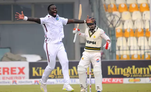 West Indies Jayden Seales, left, appeals successfully LBW dismissal of Pakistan's Kamran Ghulam, right, during the day one of the first test cricket match between Pakistan and West Indies, in Multan, Pakistan, Friday, Jan. 17, 2025. (AP Photo/Asim Tanveer)