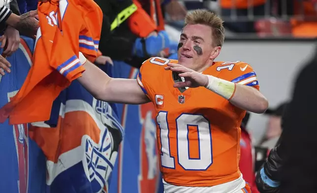 Fans congratulate Denver Broncos quarterback Bo Nix after an NFL football game against the Kansas City Chiefs, Sunday, Jan. 5, 2025, in Denver. (AP Photo/David Zalubowski)