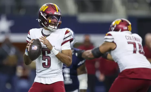 Washington Commanders quarterback Jayden Daniels looks to pass against the Dallas Cowboys during the first half of an NFL football game, Sunday, Jan. 5, 2025, in Arlington, Texas. (AP Photo/Gareth Patterson)