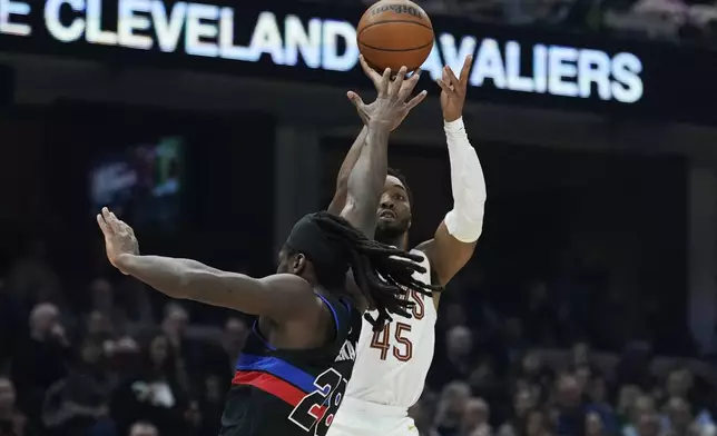 Cleveland Cavaliers guard Donovan Mitchell (45) shoots over Detroit Pistons center Isaiah Stewart (28) in the first half of an NBA basketball game, Monday, Jan. 27, 2025, in Cleveland. (AP Photo/Sue Ogrocki)