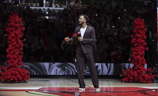 Former NBA player Derrick Rose speaks to the crowd during a half-time ceremony during an NBA basketball game between the New York Knicks and the Chicago Bulls, Saturday, Jan. 4, 2025, in Chicago. (AP Photo/Melissa Tamez)