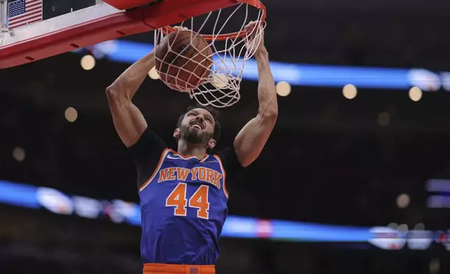 New York Knicks guard Landry Shamet slam-dunks during the first half of an NBA basketball game against the Chicago Bulls, Saturday, Jan. 4, 2025, in Chicago. (AP Photo/Melissa Tamez)