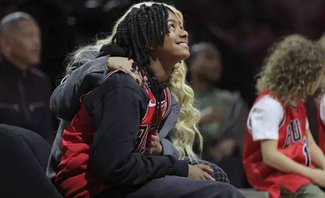 Former NBA player Derrick Rose's son PJ Rose watches the Jumbotron during a half-time ceremony during an NBA basketball game between the New York Knicks and the Chicago Bulls, Saturday, Jan. 4, 2025, in Chicago. (AP Photo/Melissa Tamez)