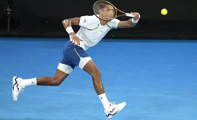 Thiago Monteiro of Brazil plays a forehand return to Kei Nishikori of Japan during their first round match at the Australian Open tennis championship in Melbourne, Australia, Sunday, Jan. 12, 2025. (AP Photo/Asanka Brendon Ratnayake)