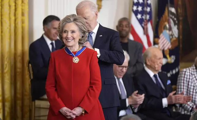 President Joe Biden, right, presents the Presidential Medal of Freedom, the Nation's highest civilian honor, to former Secretary of State Hillary Clinton, in the East Room of the White House, Saturday, Jan. 4, 2025, in Washington. (AP Photo/Manuel Balce Ceneta)