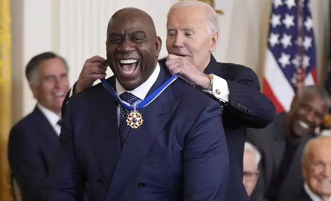 President Joe Biden, right, presents the Presidential Medal of Freedom, the Nation's highest civilian honor, to Earvin "Magic" Johnson in the East Room of the White House, Saturday, Jan. 4, 2025, in Washington. (AP Photo/Manuel Balce Ceneta)