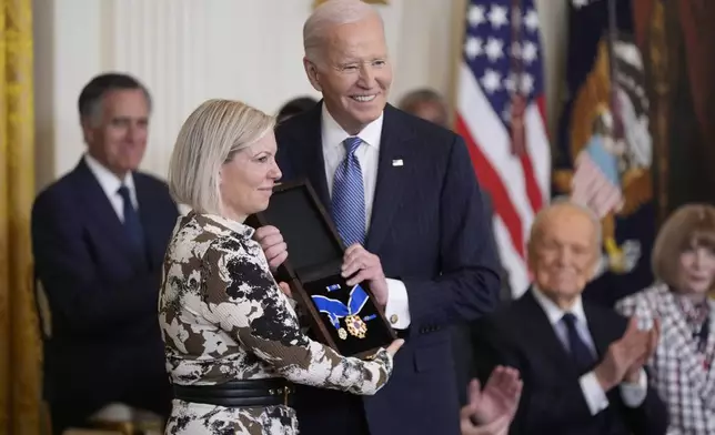 President Joe Biden, right, posthumously presents the Presidential Medal of Freedom, the Nation's highest civilian honor, to Stephanie Carter, left, on behalf of her late husband former Defense Secretary Ash Carter, in the East Room of the White House, Saturday, Jan. 4, 2025, in Washington. (AP Photo/Manuel Balce Ceneta)