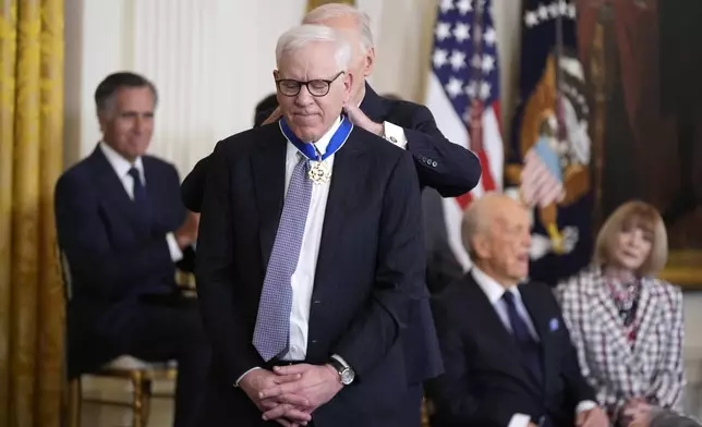 President Joe Biden, right, presents the Presidential Medal of Freedom, the Nation's highest civilian honor, to David Rubenstein in the East Room of the White House, Saturday, Jan. 4, 2025, in Washington. (AP Photo/Manuel Balce Ceneta)