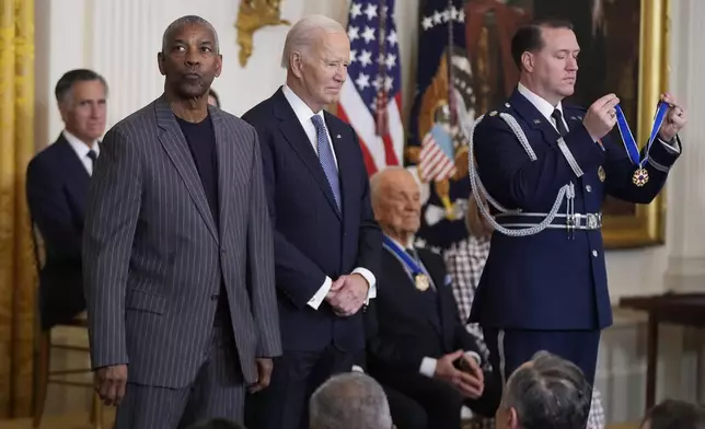 President Joe Biden, center, prepares to present the Presidential Medal of Freedom, the Nation's highest civilian honor, to Denzel Washington in the East Room of the White House, Saturday, Jan. 4, 2025, in Washington. (AP Photo/Manuel Balce Ceneta)