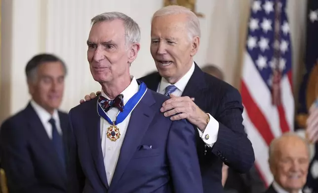 President Joe Biden, right, presents the Presidential Medal of Freedom, the Nation's highest civilian honor, to Bill Nye in the East Room of the White House, Saturday, Jan. 4, 2025, in Washington. (AP Photo/Manuel Balce Ceneta)