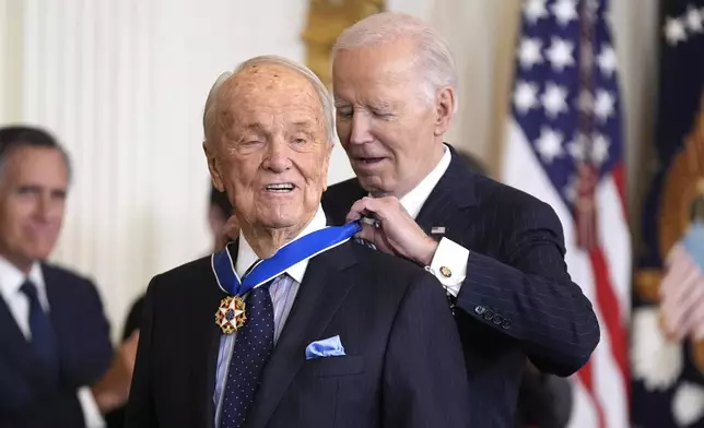 President Joe Biden, right, presents the Presidential Medal of Freedom, the Nation's highest civilian honor, to writer George Stevens, Jr. in the East Room of the White House, Saturday, Jan. 4, 2025, in Washington. (AP Photo/Manuel Balce Ceneta)