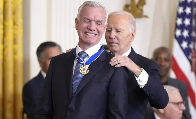 President Joe Biden, right, presents the Presidential Medal of Freedom, the Nation's highest civilian honor, to Tim Gill in the East Room of the White House, Saturday, Jan. 4, 2025, in Washington. (AP Photo/Manuel Balce Ceneta)