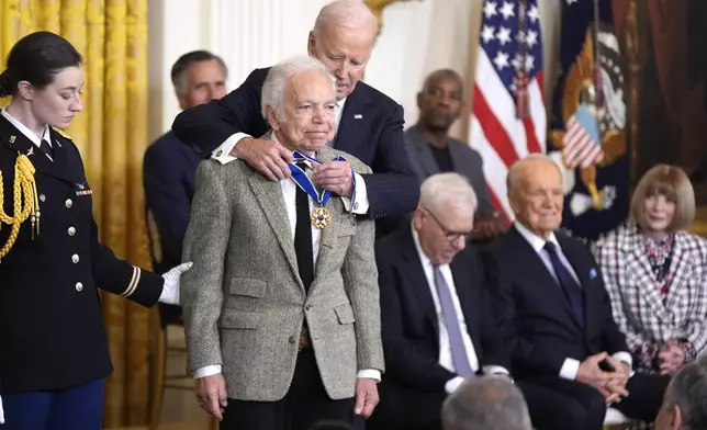 President Joe Biden, right, presents the Presidential Medal of Freedom, the Nation's highest civilian honor, to fashion designer Ralph Lauren in the East Room of the White House, Saturday, Jan. 4, 2025, in Washington. (AP Photo/Manuel Balce Ceneta)