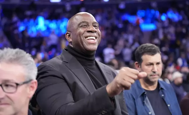 FILE - Magic Johnson waves to people before an NBA basketball game between the New York Knicks and the Los Angeles Lakers Saturday, Feb. 3, 2024, in New York. (AP Photo/Frank Franklin II, File)