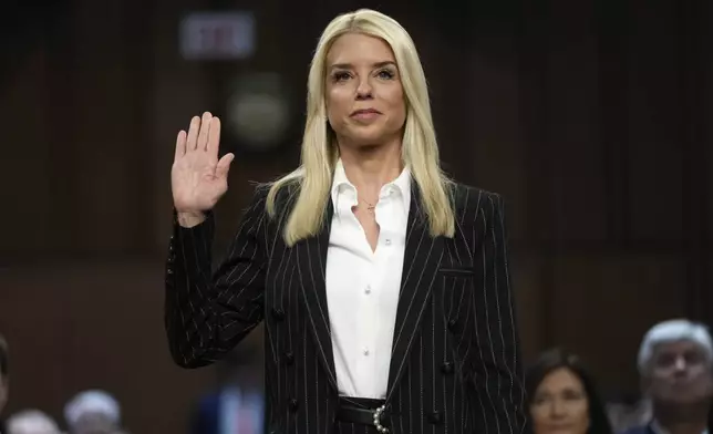 Pam Bondi, President-elect Donald Trump's choice to lead the Justice Department as attorney general, is sworn in before the Senate Judiciary Committee for her confirmation hearing, at the Capitol in Washington, Wednesday, Jan. 15, 2025. (AP Photo/Ben Curtis)
