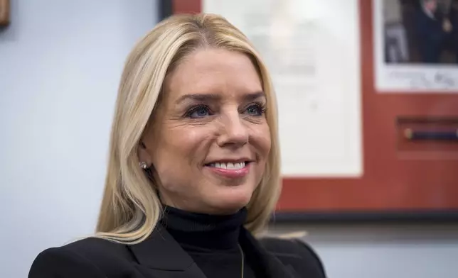 FILE - Pam Bondi, President-elect Donald Trump's nominee for Attorney General, listens during a meeting with Sen. Lindsey Graham, R-S.C., at the Capitol in Washington, Dec. 2, 2024. (AP Photo/J. Scott Applewhite, File)