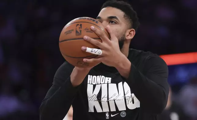 New York Knicks' Karl-Anthony Towns wears a warmup shirt in honor of Martin Luther King Jr. before an NBA basketball game against the Atlanta Hawks, Monday, Jan. 20, 2025, in New York. (AP Photo/Heather Khalifa)