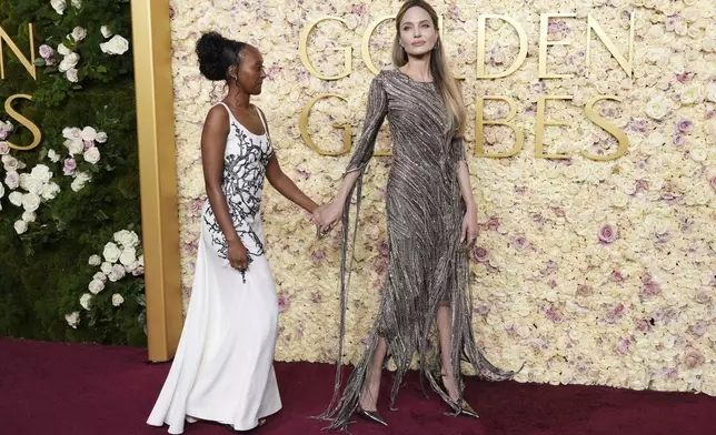 Zahara Jolie, left, and Angelina Jolie arrive at the 82nd Golden Globes on Sunday, Jan. 5, 2025, at the Beverly Hilton in Beverly Hills, Calif. (Photo by Jordan Strauss/Invision/AP)