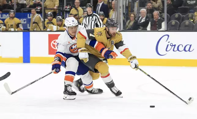 New York Islanders left wing Anders Lee, left, collides with Vegas Golden Knights defenseman Alex Pietrangelo, right, during the first period of an NHL hockey game Thursday, Jan. 9, 2025, in Las Vegas. (AP Photo/Ian Maule)