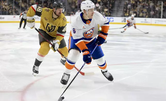 New York Islanders defenseman Ryan Pulock (6) skates past Vegas Golden Knights center Tomas Hertl (48) during the first period of an NHL hockey game Thursday, Jan. 9, 2025, in Las Vegas. (AP Photo/Ian Maule)