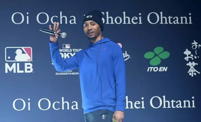 Los Angeles Dodgers right fielder Mookie Betts waves a he arrives for a sponsor's promotional event in Tokyo, Tuesday, Jan. 21, 2025. (AP Photo/Eugene Hoshiko)