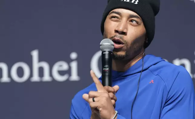 Los Angeles Dodgers right fielder Mookie Betts speaks during a sponsor's promotional event in Tokyo, Tuesday, Jan. 21, 2025. (AP Photo/Eugene Hoshiko)
