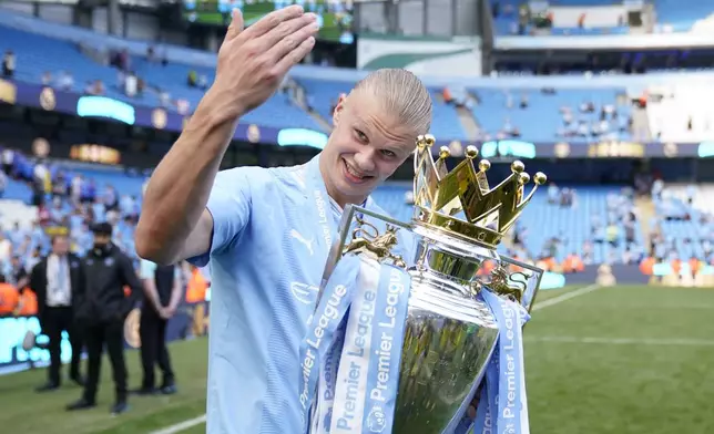 FILE -Manchester City's Erling Haaland celebrates with the Premier League trophy after the English Premier League soccer match between Manchester City and West Ham United at the Etihad Stadium in Manchester, England, May 19, 2024. (AP Photo/Dave Thompson, File)