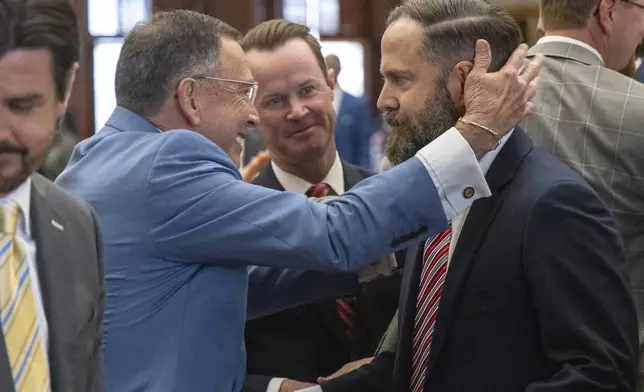 Texas state Rep. Jay Dean, R-Longview, at left, former Speaker Dade Phelan, R-Beaumont, celebrate Texas state Rep. Dustin Burrows, R-Lubbock, winning the speakership during opening day of the 89th Texas Legislative Session in Austin, Tuesday, Jan. 14, 2025. (AP Photo/Stephen Spillman)
