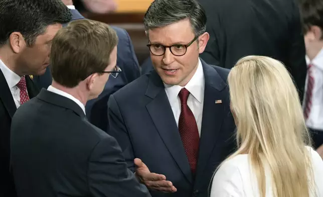 House Speaker Mike Johnson, R-La., speaks with Rep. Dusty Johnson, R-S.D., left, and Rep. Marjorie Taylor Greene, R-Ga., right, as the House of Representatives convenes the 119th Congress with a slim Republican majority, at the Capitol in Washington, Friday, Jan. 3, 2025. (AP Photo/J. Scott Applewhite)