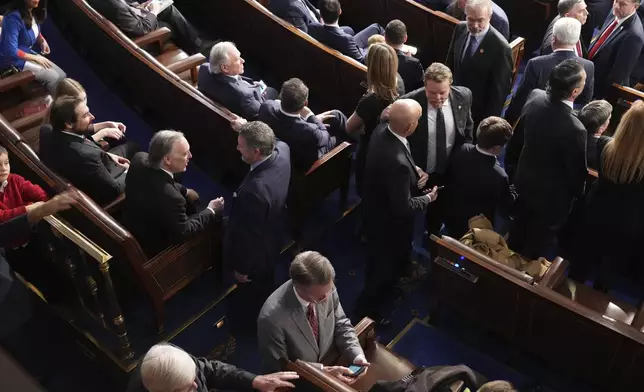 Members of the Freedom Caucus gather at the back of the room during the roll call as the House of Representatives meets to elect a speaker and convene the new 119th Congress at the Capitol in Washington, Friday, Jan. 3, 2025. (AP Photo/Jacquelyn Martin)