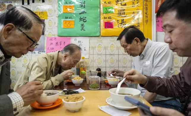 Customers dine at the family-run snake soup restaurant in Hong Kong, Monday, Jan. 6, 2025. (AP Photo/Chan Long Hei)