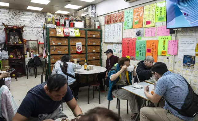 Customers dine at the family-run snake soup restaurant in Hong Kong, Monday, Jan. 6, 2025. (AP Photo/Chan Long Hei)