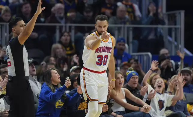 Golden State Warriors guard Stephen Curry reacts after making a 3-point basket during the first half of an NBA basketball game against the Philadelphia 76ers, Thursday, Jan. 2, 2025, in San Francisco. (AP Photo/Godofredo A. Vásquez)