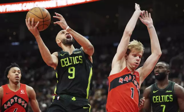 Boston Celtics' Derrick White (9) shoots over Toronto Raptors' Gradey Dick (1) during second half NBA basketball action in Toronto on Wednesday, January 15, 2025. (Frank Gunn/The Canadian Press via AP)