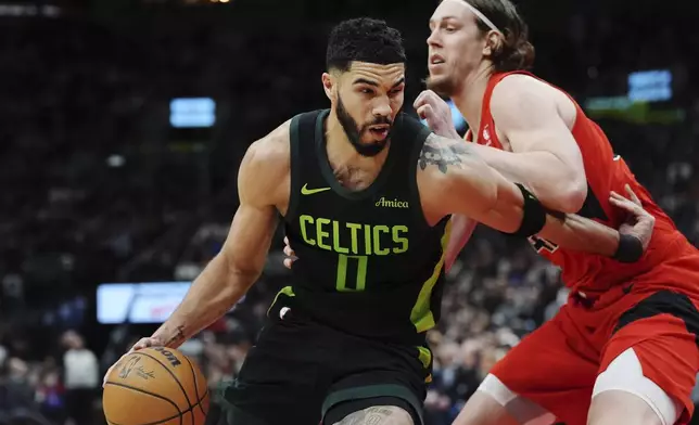 Boston Celtics' Jayson Tatum (0) drives as Toronto Raptors' Kelly Olynyk (41) defends during the second half of an NBA basketball game in Toronto on Wednesday, Jan. 15, 2025. (Frank Gunn/The Canadian Press via AP)