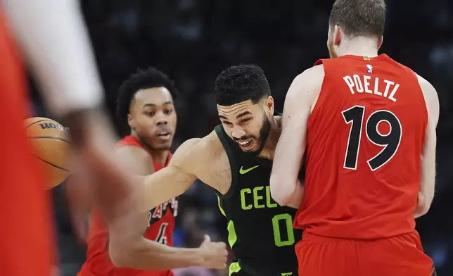 Boston Celtics' Jayson Tatum (0) runs into Toronto Raptors' Jakob Poeltl (19) during the second half of an NBA basketball game in Toronto on Wednesday, Jan. 15, 2025. (Frank Gunn/The Canadian Press via AP)