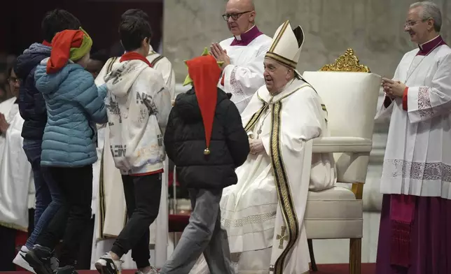 Children bring the offertory during an Epiphany mass presided by Pope Francis in St.Peter's Basilica, at the Vatican, Monday, Jan. 6, 2025. (AP Photo/Alessandra Tarantino)