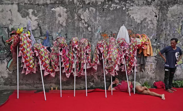Members of dragon dance club Naga Merah Putih (Red White Dragon), named after Indonesian national colors, take a break after a training in Bogor, West Java, Indonesia, Wednesday, Jan. 22, 2025. (AP Photo/Dita Alangkara)