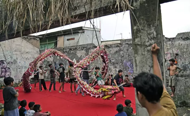 Members of dragon dance club Naga Merah Putih (Red White Dragon) which is named after Indonesian national colors, practice in Bogor, West Java, Indonesia, Wednesday, Jan. 22, 2025. (AP Photo/Dita Alangkara)
