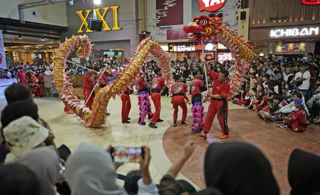 Members of dragon dance club Naga Merah Putih (Red White Dragon) which is named after Indonesian national colors, perform in a Lunar New Year celebration at a shopping mall in Bogor, West Java, Indonesia, Sunday, Jan. 26, 2025. (AP Photo/Dita Alangkara)