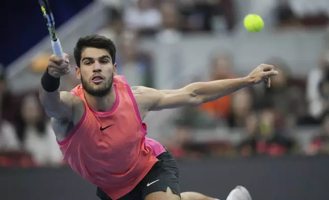 FILE - Carlos Alcaraz of Spain returns a shot from Jannik Sinner of Italy during their men's singles finals match of the China Open tennis tournament, at the National Tennis Center in Beijing, Wednesday, Oct. 2, 2024. (AP Photo/Achmad Ibrahim, File)