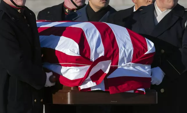 A joint services military body bearer team carries the flag-draped casket of former President Jimmy Carter from the U.S. Capitol on the way to a state funeral at the National Cathedral in Washington, Thursday, Jan. 9, 2025. (AP Photo/Jose Luis Magana)