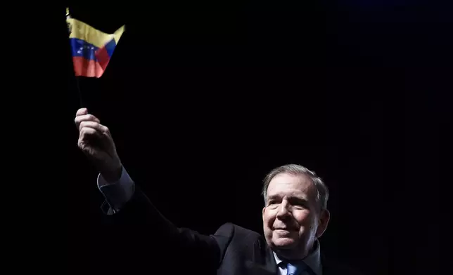 Venezuela's opposition leader Edmundo Gonzalez waves a Venezuelan flag during a meeting with supporters in Panama City, Wednesday, Jan. 8, 2025. (AP Photo/Agustin Herrera)