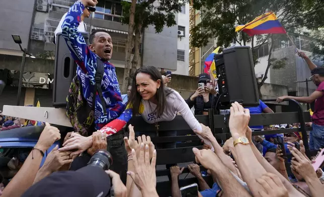 Opposition leader Maria Corina Machado greets supporters during a protest against Venezuelan President Nicolas Maduro the day before his inauguration for a third term in Caracas, Venezuela, Thursday, Jan. 9, 2025. (AP Photo/Matias Delacroix)