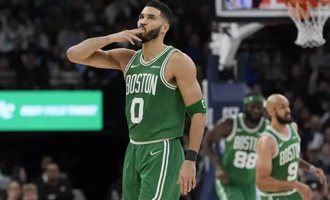 Boston Celtics forward Jayson Tatum (0) gestures after making a 3-point shot during the first half of an NBA basketball game against the Minnesota Timberwolves, Thursday, Jan. 2, 2025, in Minneapolis. (AP Photo/Abbie Parr)