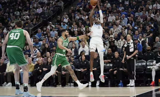 Minnesota Timberwolves forward Jaden McDaniels (3) shoots over Boston Celtics forward Jayson Tatum (0) during the first half of an NBA basketball game, Thursday, Jan. 2, 2025, in Minneapolis. (AP Photo/Abbie Parr)