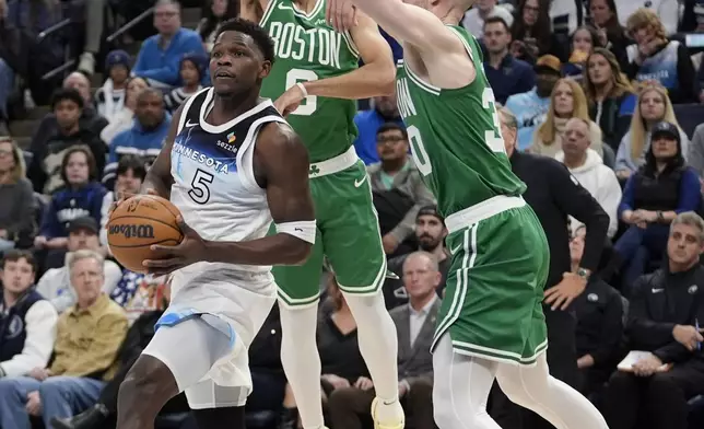 Minnesota Timberwolves guard Anthony Edwards (5) looks to pass while defended by Boston Celtics guard Derrick White (9), back, forward Sam Hauser (30), right, during the first half of an NBA basketball game, Thursday, Jan. 2, 2025, in Minneapolis. (AP Photo/Abbie Parr)