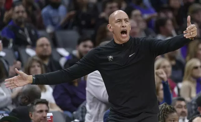 Sacramento Kings interim head coach Doug Christie shouts instructions to his team during the first half of an NBA basketball game against the Philadelphia 76ers in Sacramento, Calif., Wednesday, Jan. 1, 2025. (AP Photo/Randall Benton)