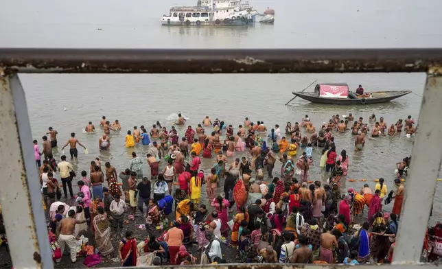 Hindu pilgrims take a holy dip at Hooghly River on the auspicious occasion of Makar Sankranti, in Kolkata, India, Tuesday, Jan. 14, 2025. (AP Photo/Bikas Das)